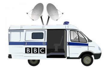 A police van outfitted with satellite antenna and the BBC logo on its sliding door. 